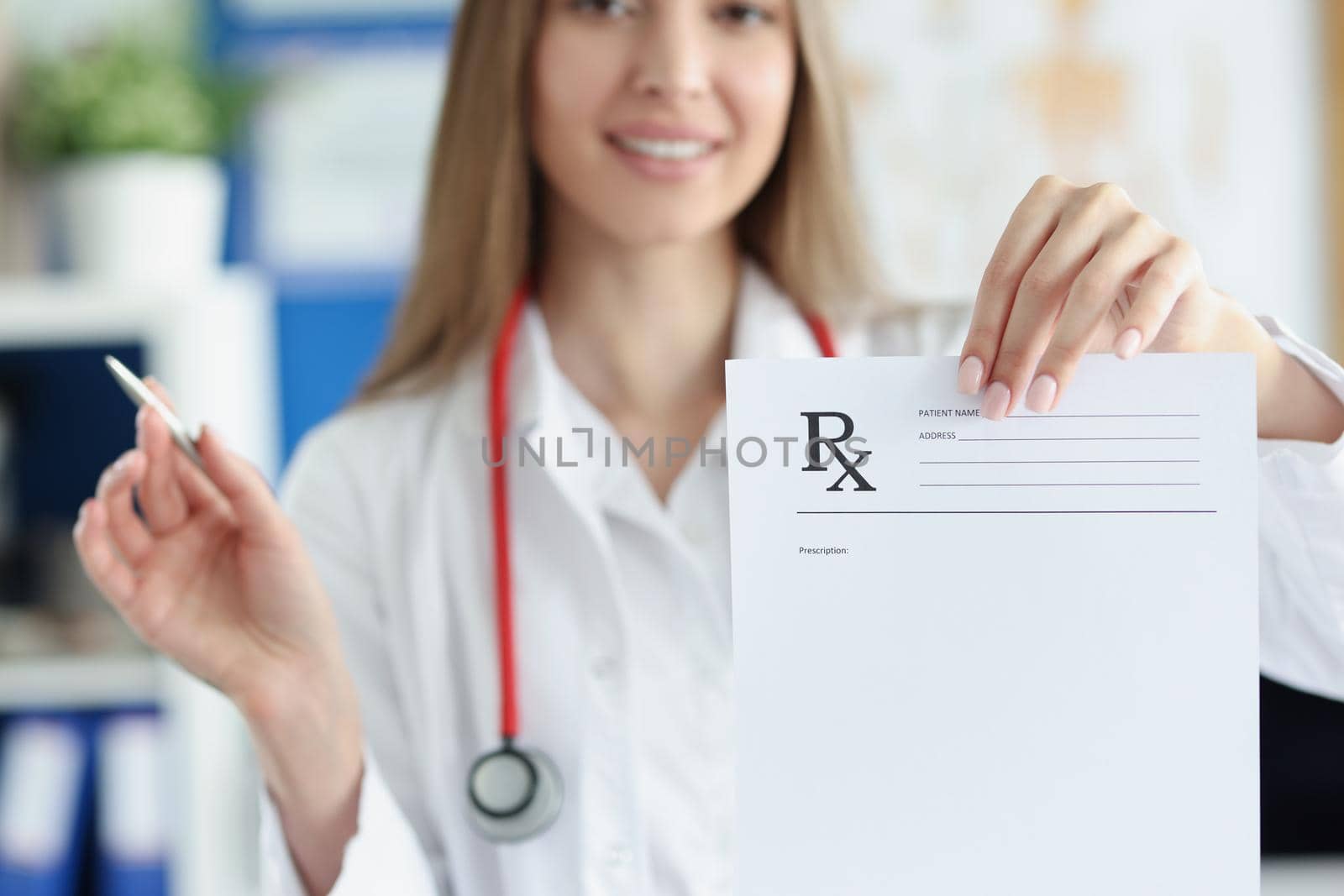 Portrait of smiling woman doctor hold prescription recipe in one hand and pen in another. Prescription paper for patient. Medicine, checkup, clinic concept