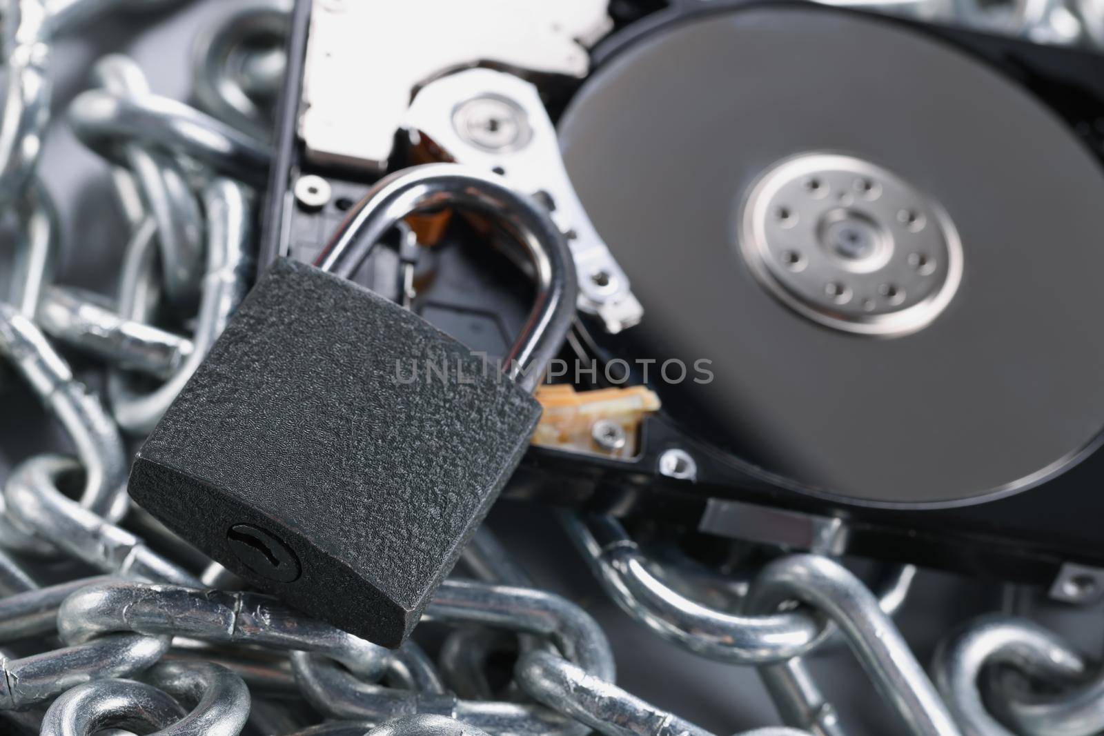 Data on cd rom secured with chain and padlock equipment, key hole by kuprevich