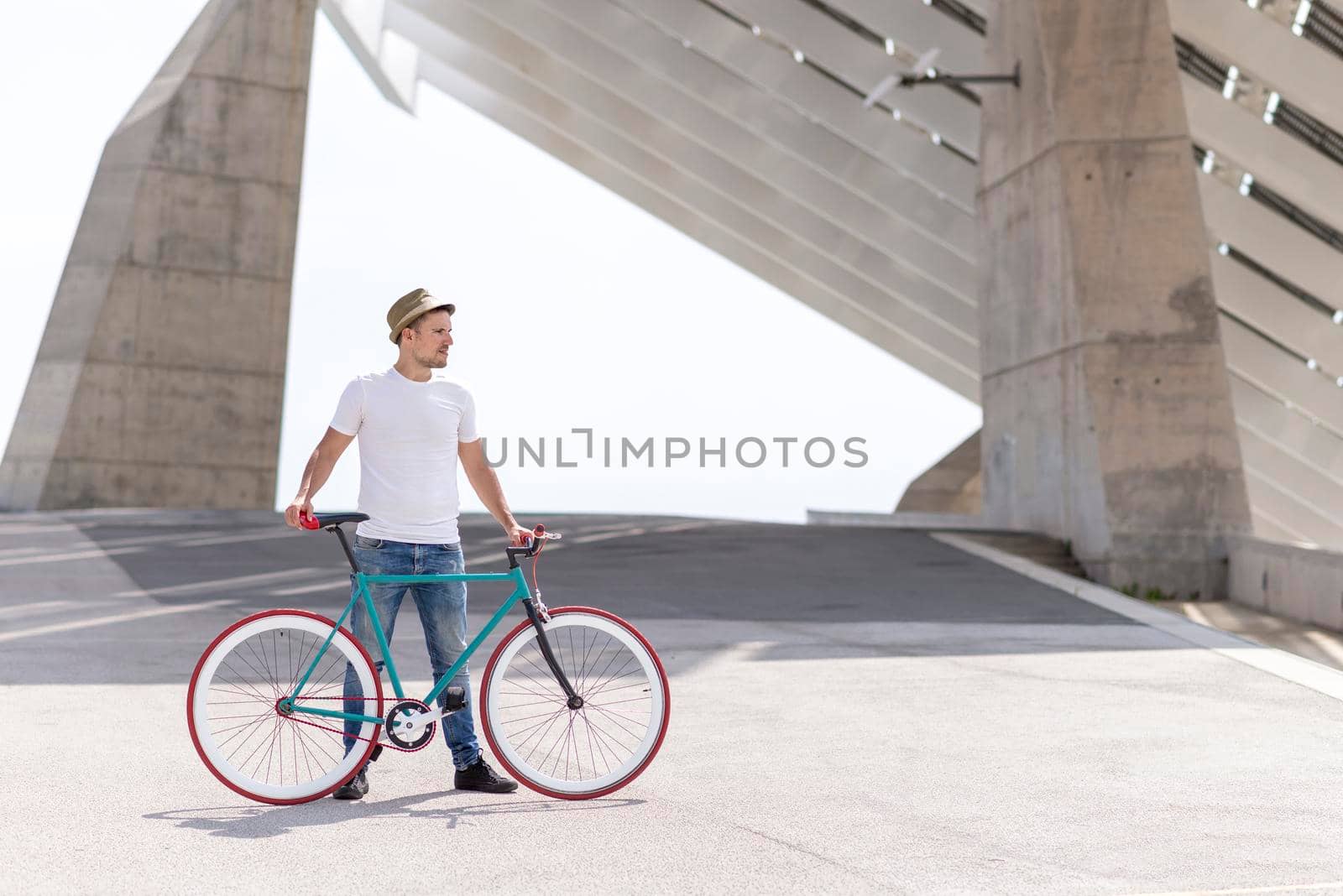 Young Man Biking in a Summer Day on the city by raferto1973