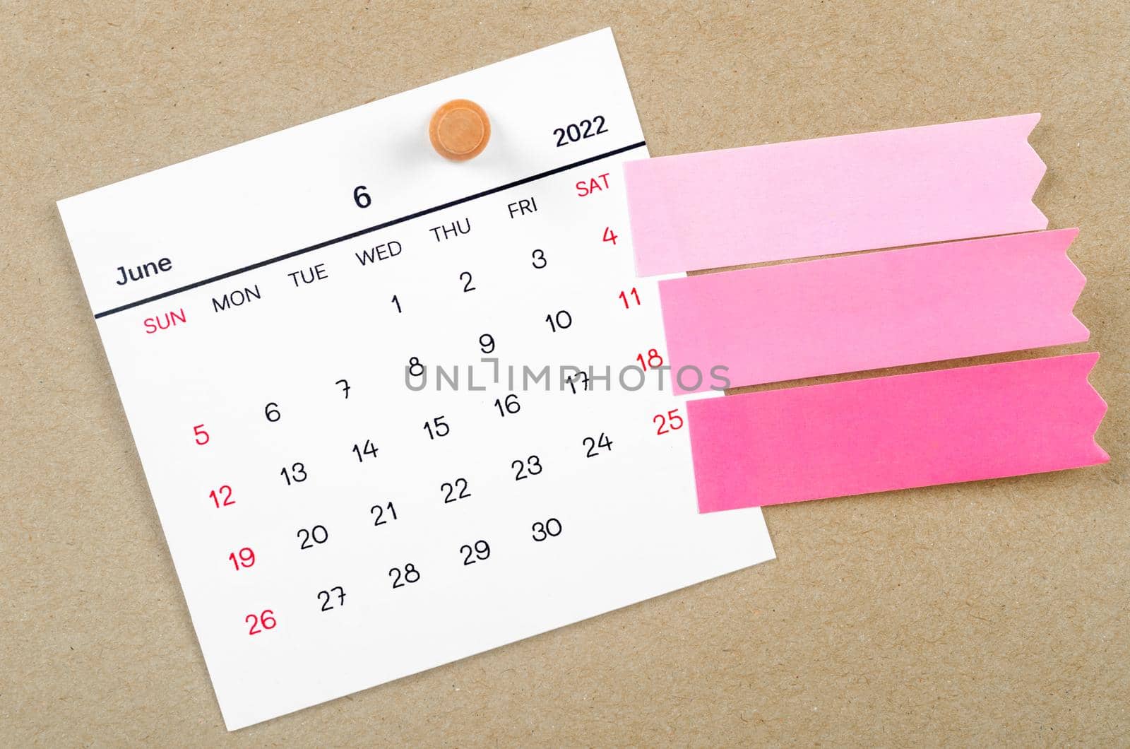 June 2022 calendar with blank adhesive note paper on brown background.