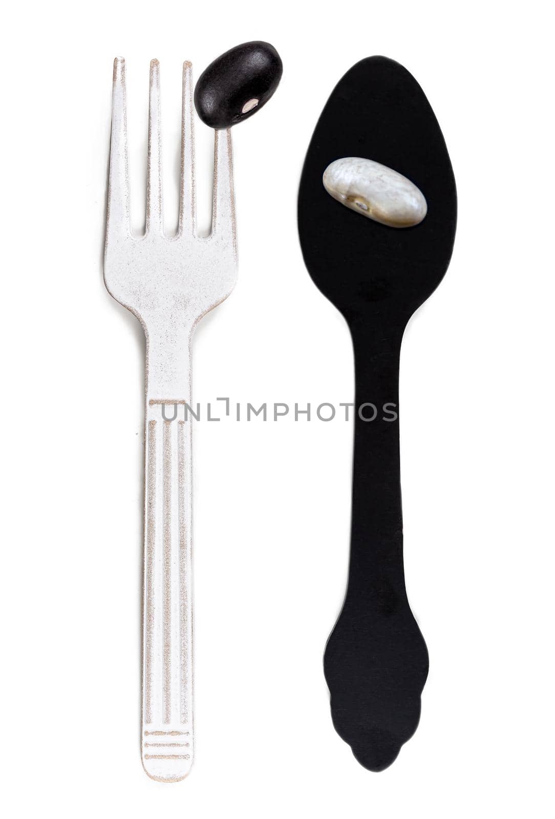 White bean and black bean on spoon and fouchette - Inverted tones.