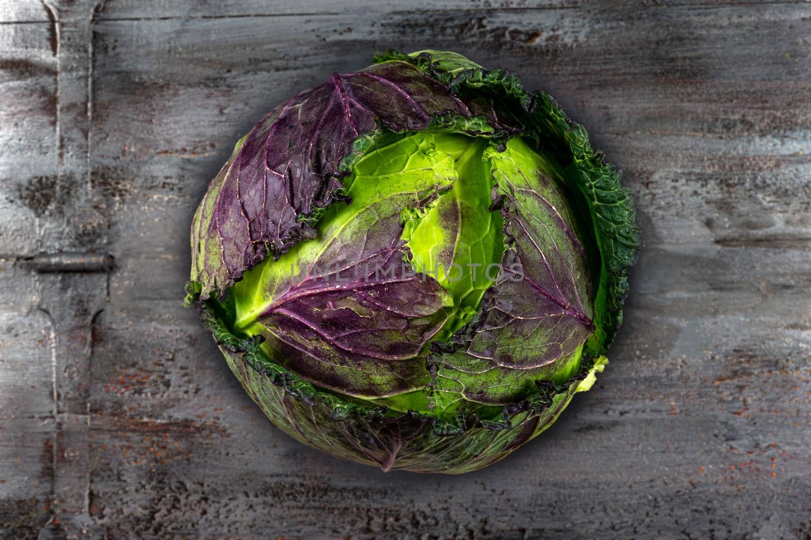 Green and red cabbage in close-up on old board