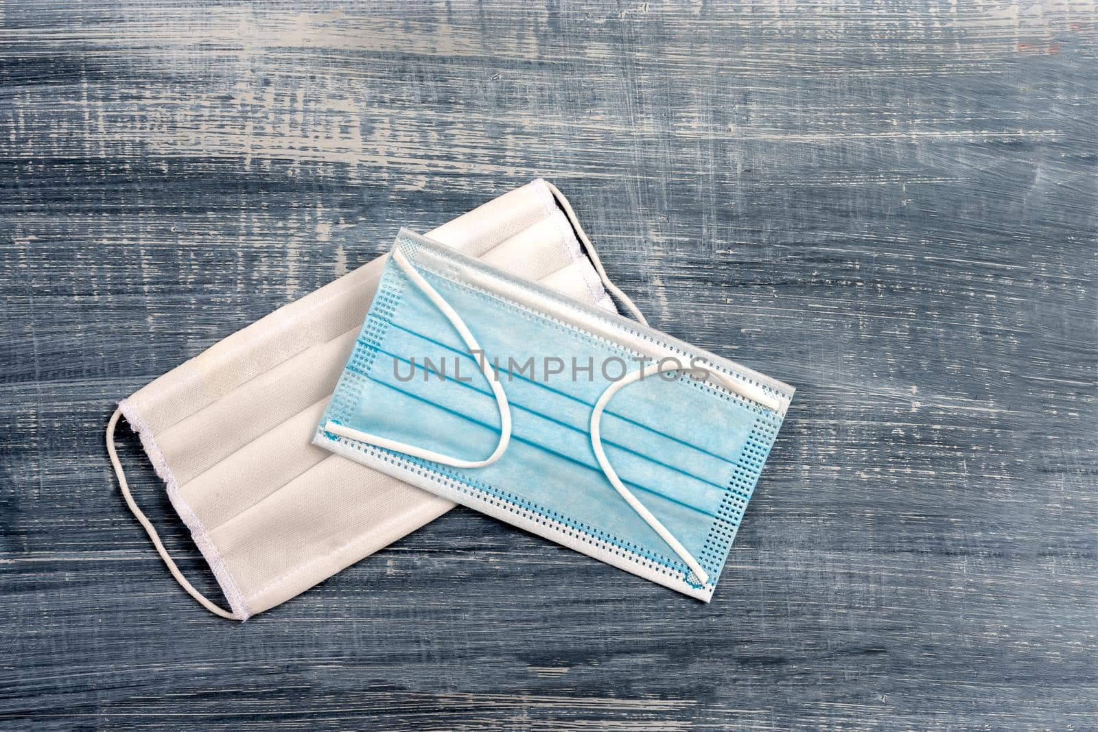 surgical masks blue and whitre on grey background by JPC-PROD