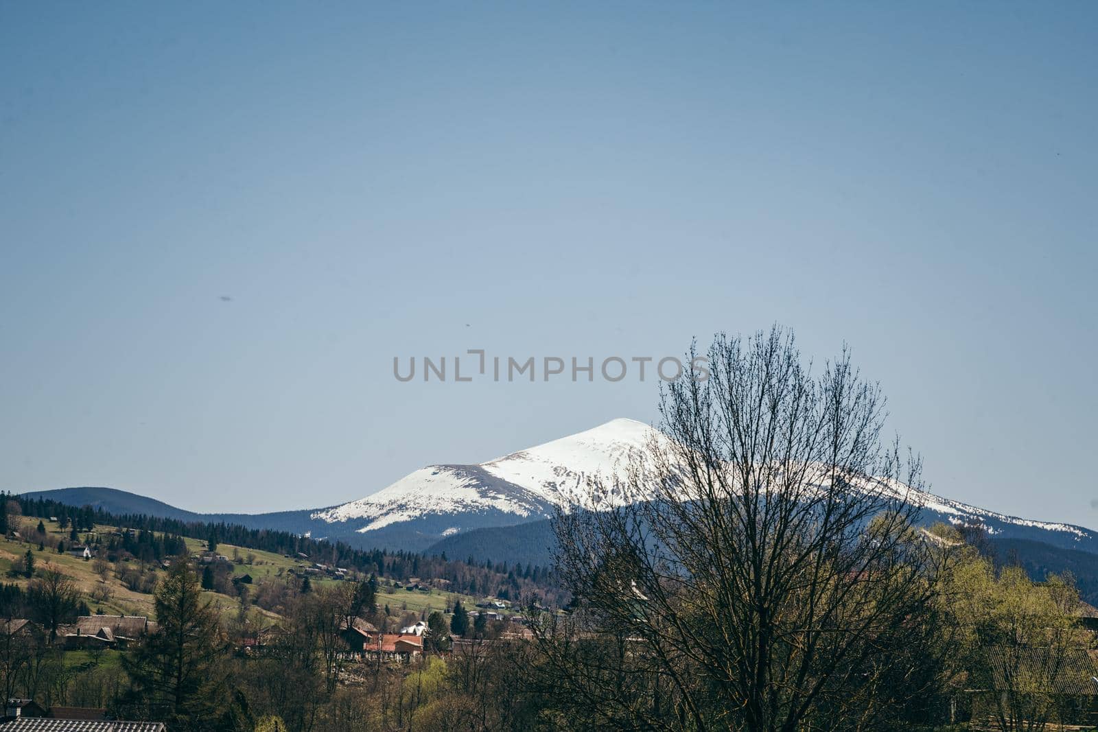 Snow-capped mountain on the horizon, and mountain villages. High quality photo