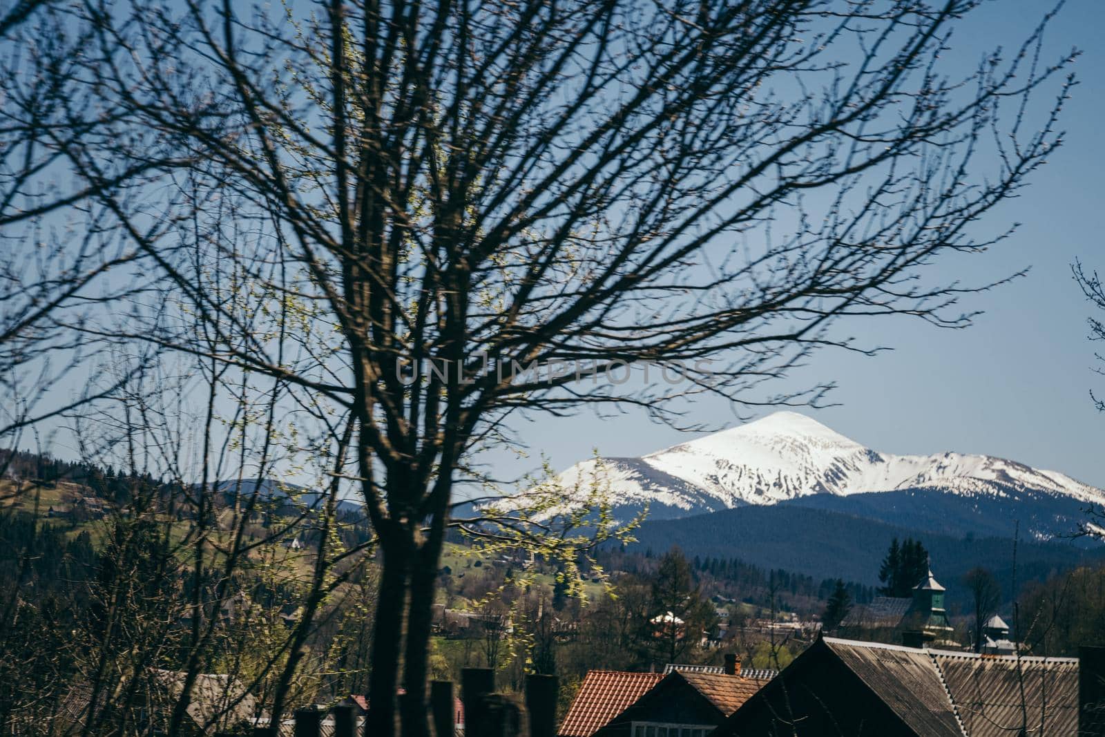 Snow-capped mountain on the horizon, and mountain villages. High quality photo