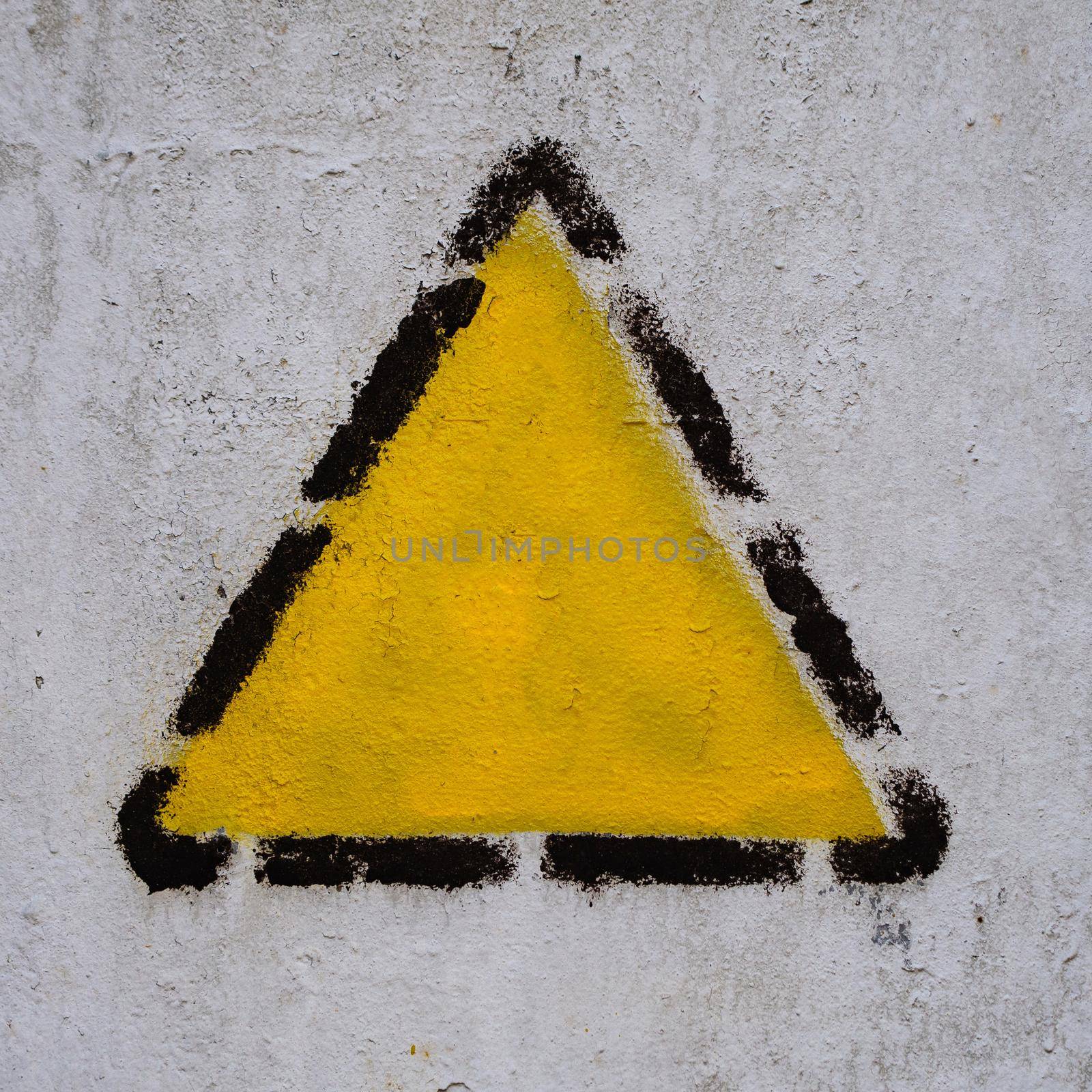 Yellow triangle, square, rhombus in black dotted frame on the old common wall. copy space