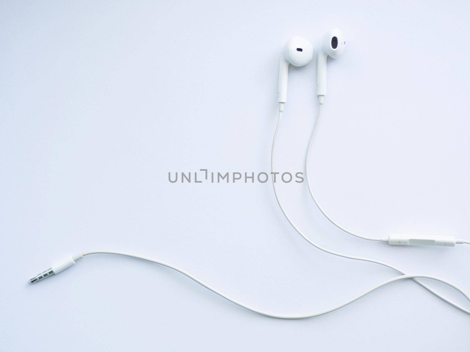 White wired headphones, headset on a white background. Musical day