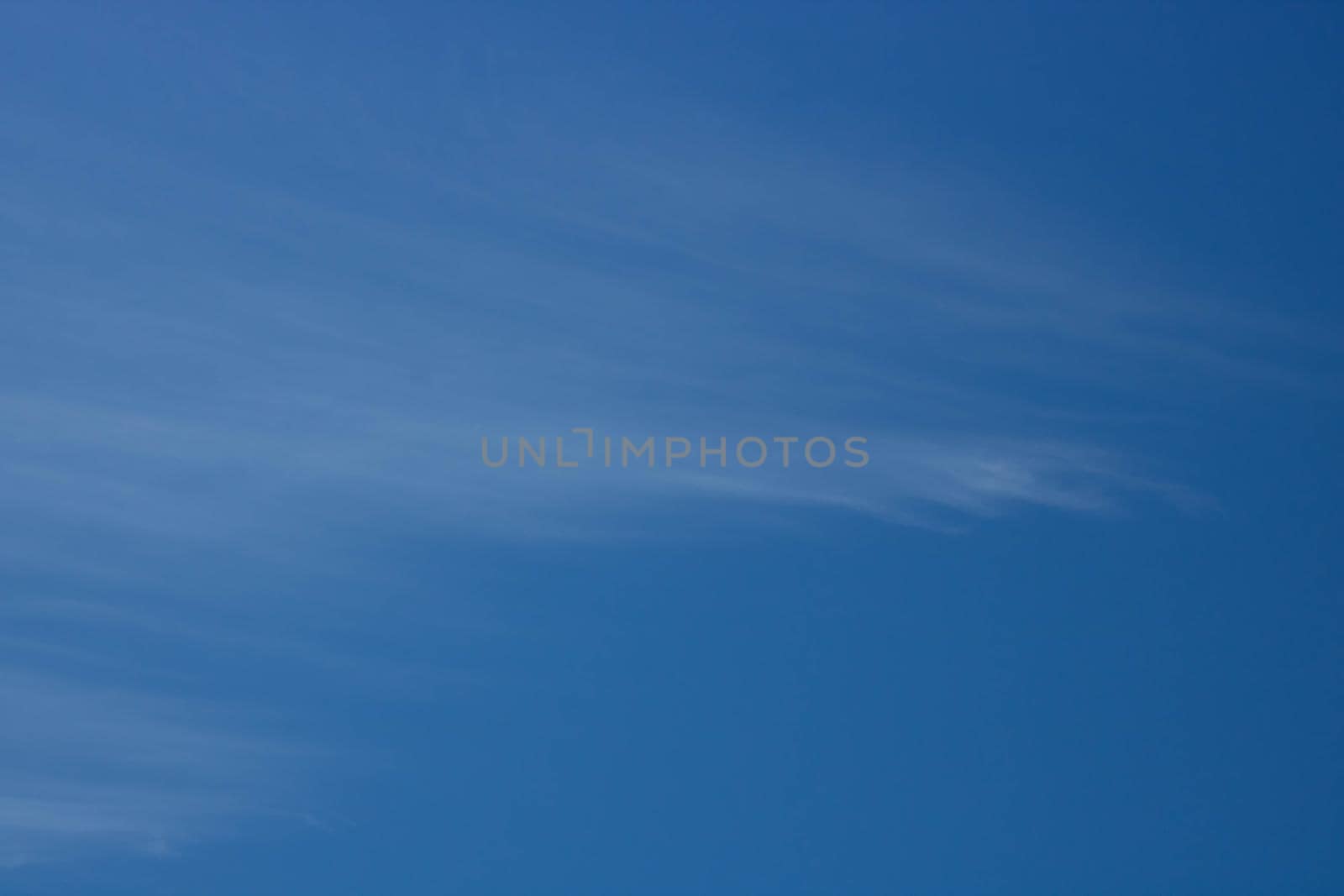 Beautiful sky background. Unusual cirrus clouds in the blue sky by lapushka62