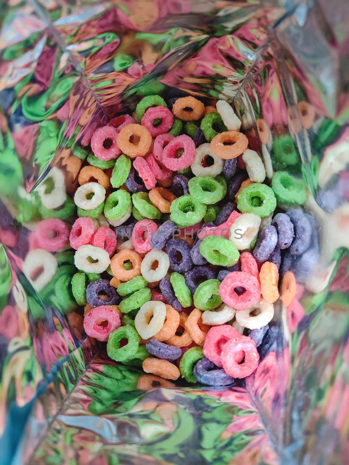 Colorful fruit corn cereal rings in bag. close up shot of this nutritious and delicious breakfast and snack favorite. by Nickstock