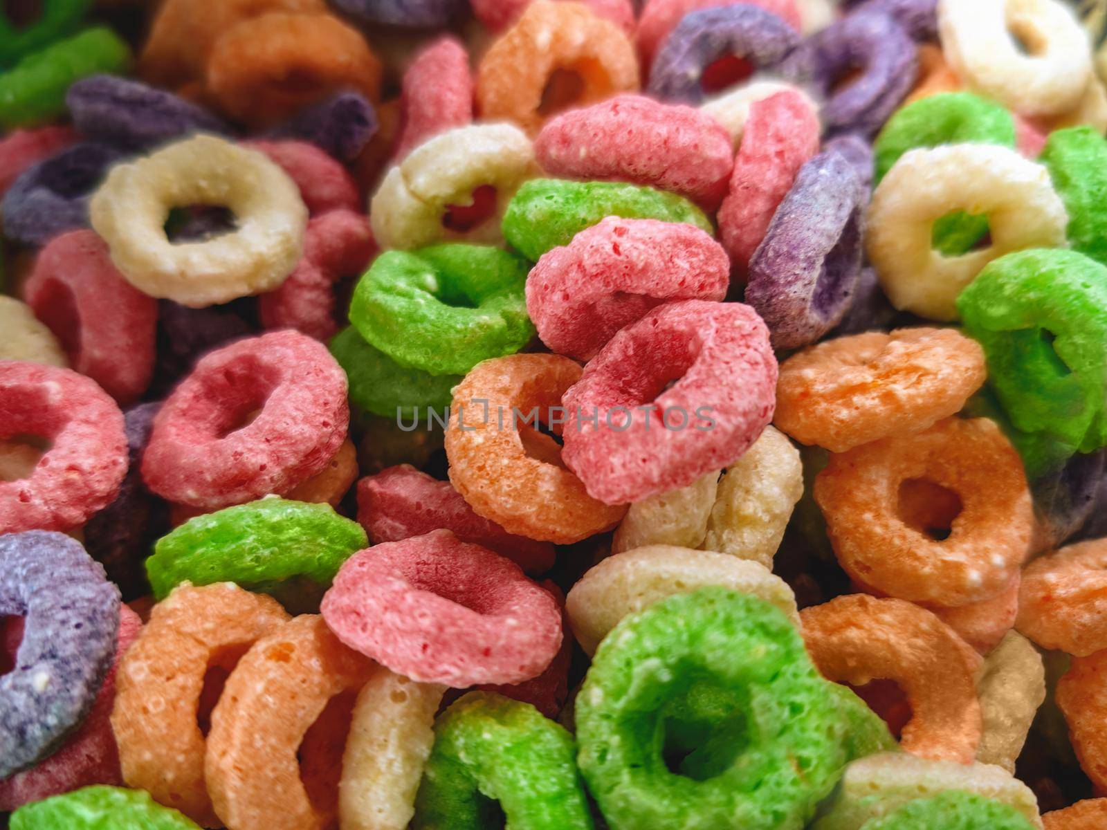 Colorful fruit corn cereal rings. Highly detailed macro close up shot of this nutritious and delicious breakfast and snack favorite. by Nickstock