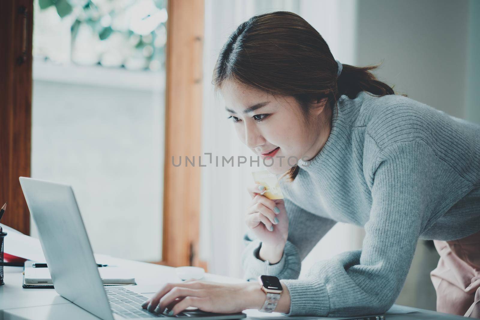 Woman enjoy with online shopping application and typing credit card for fill number to payment with virtual digital asset and metaverse. by itchaznong