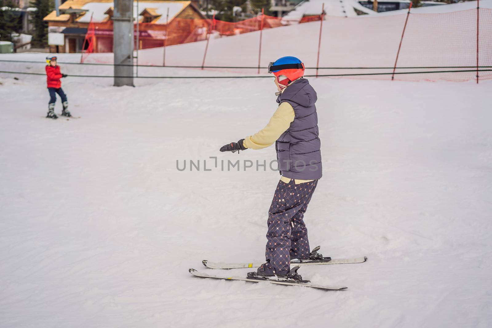 Woman learning to ski. Young woman skiing on a snowy road in the mountains.