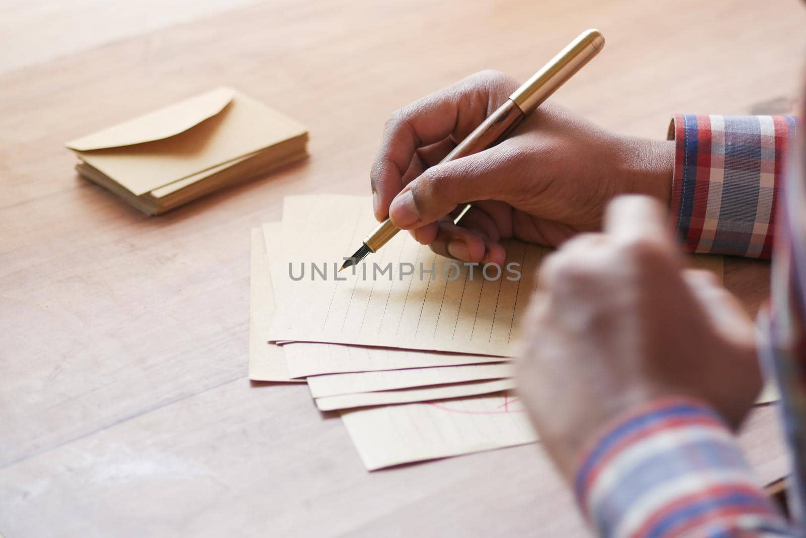 envelope , empty paper and fountain pen on table .