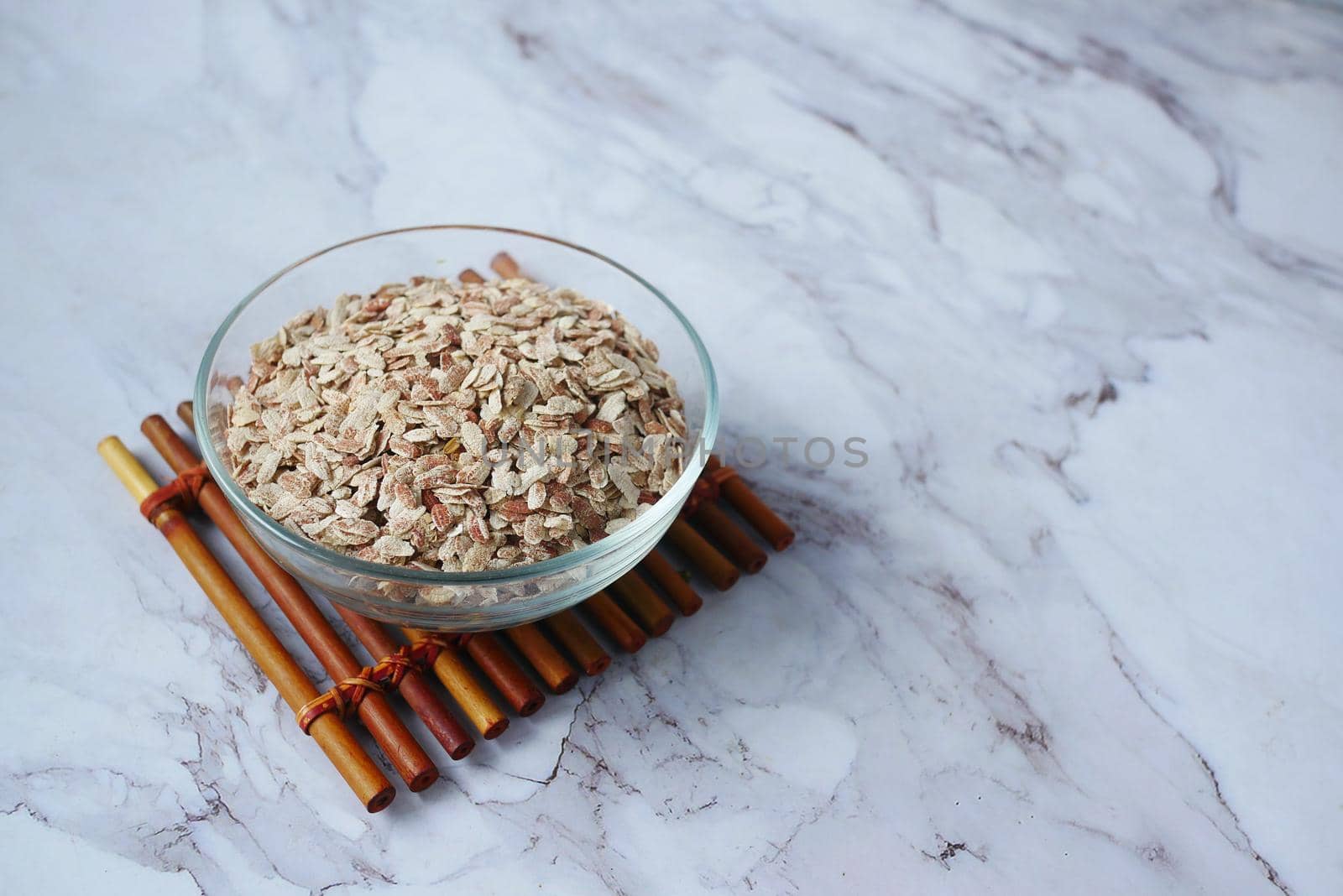 red Flattened rice in a bowl on gray background .