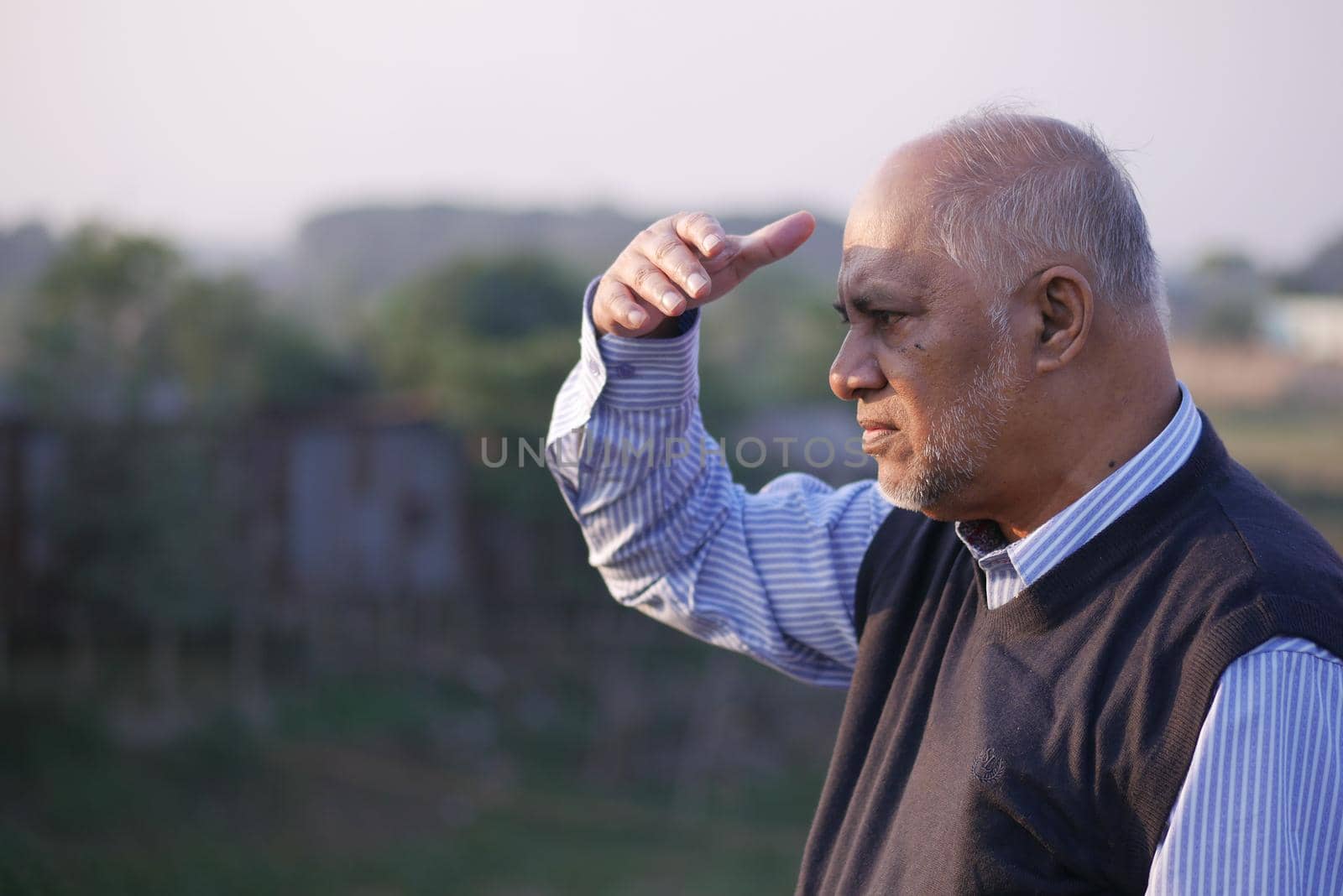 senior man looking away in park .