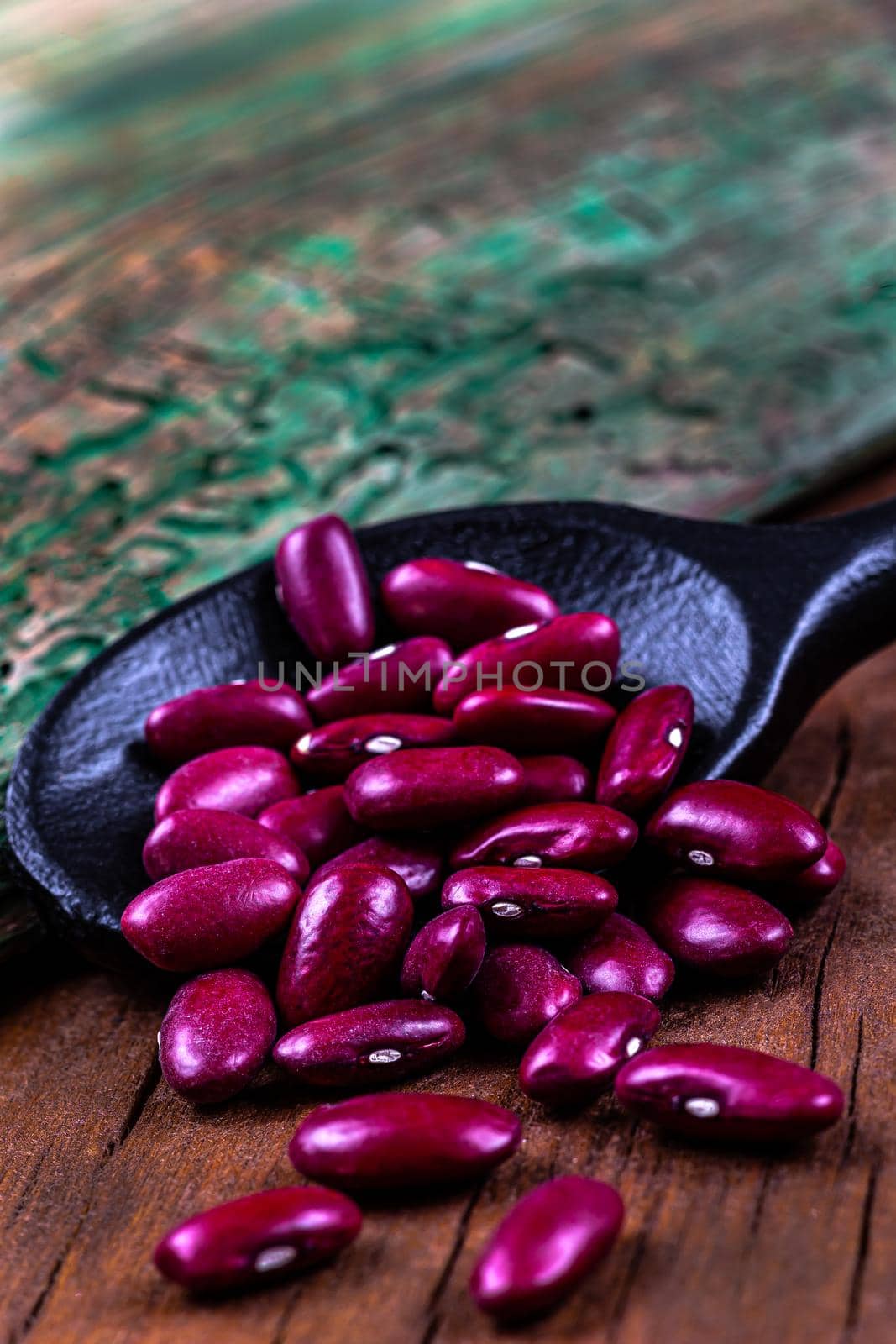 Red beans in close-up in a wooden spoon