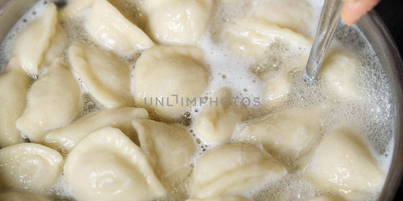 Meat Dumplings in boiling water. Meat dumplings are boiled in a pot of boiling water. Home fast food