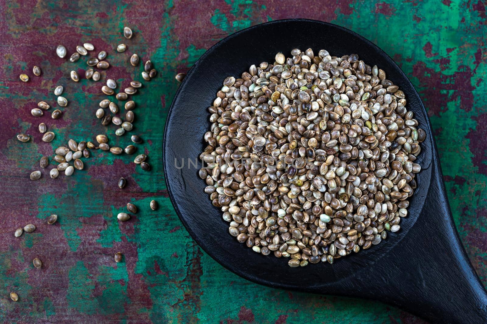 Hemp seeds in a wooden spoon seen from above