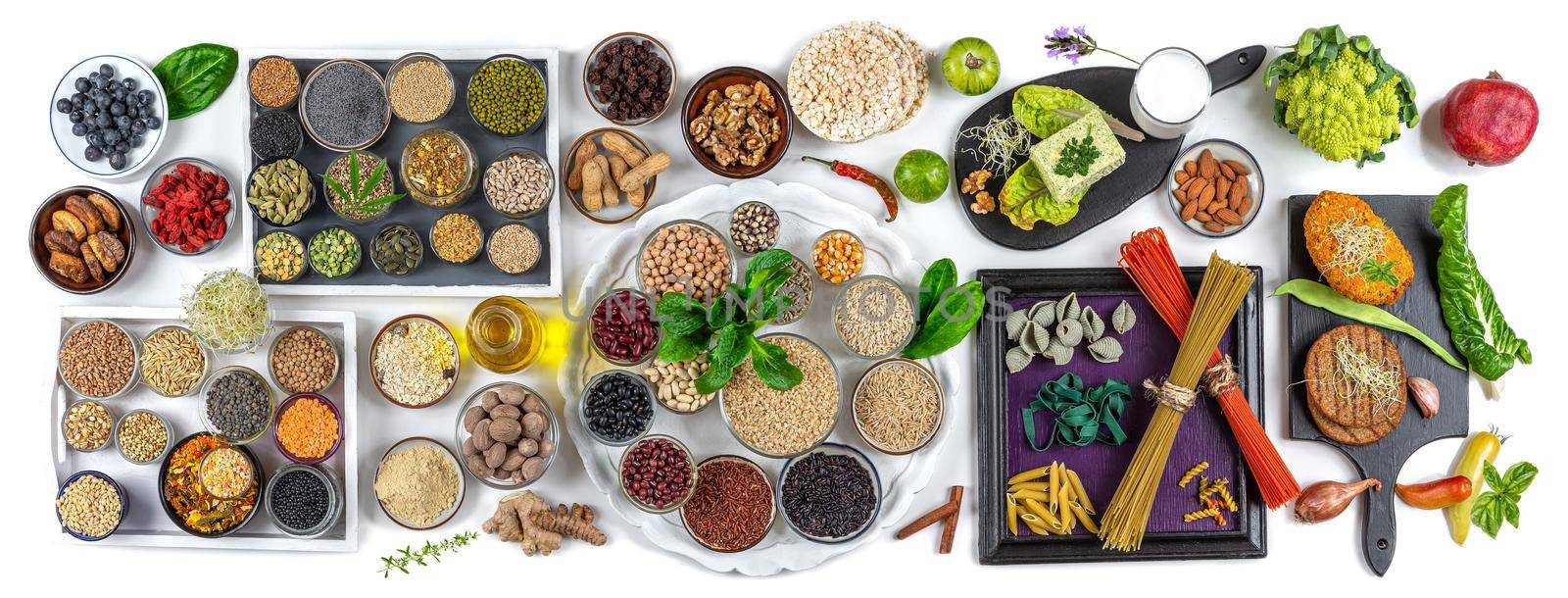Panoramic on the essentials of vegan food - top view on a white background