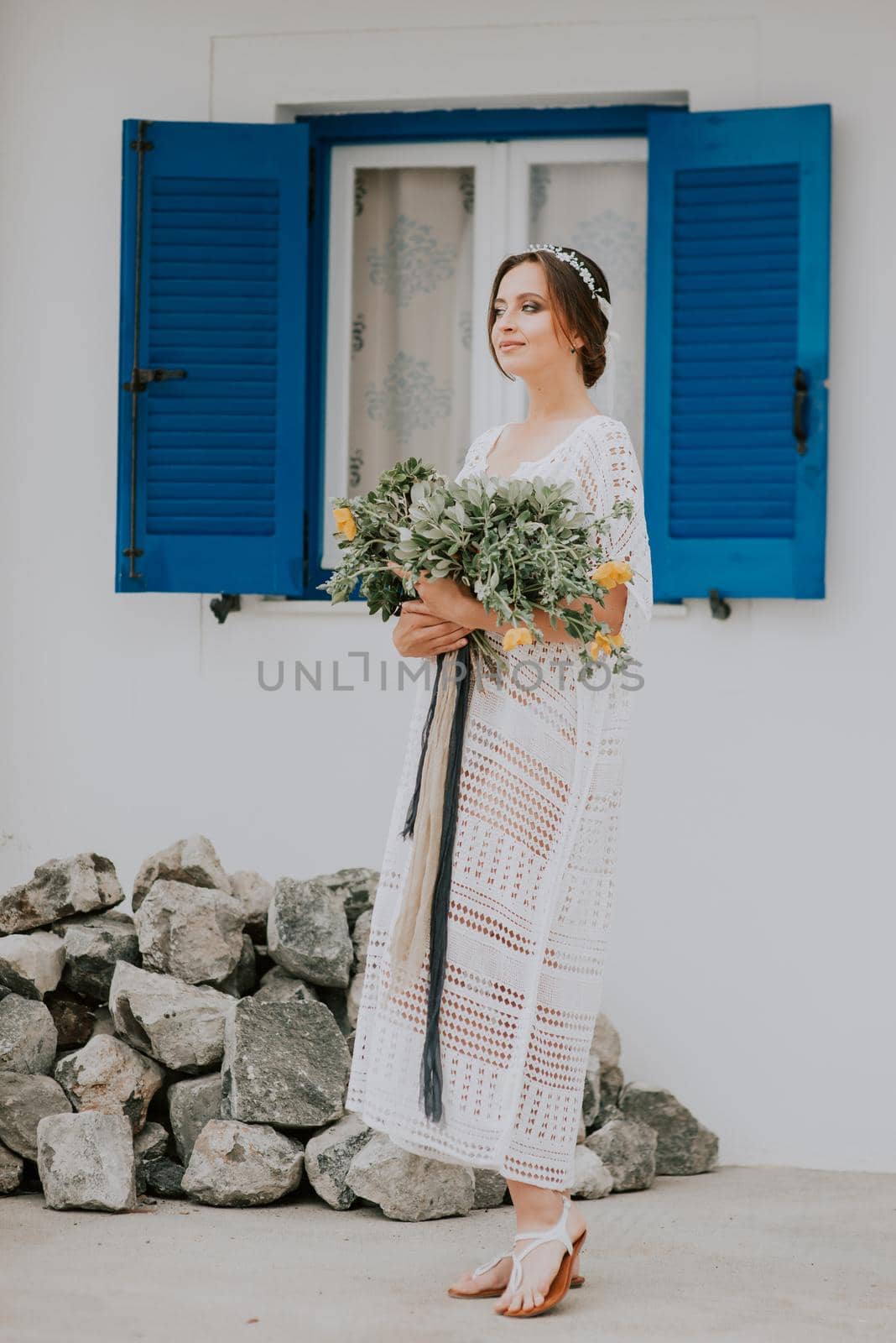 Young attractive bride with the bouquet of flowers.