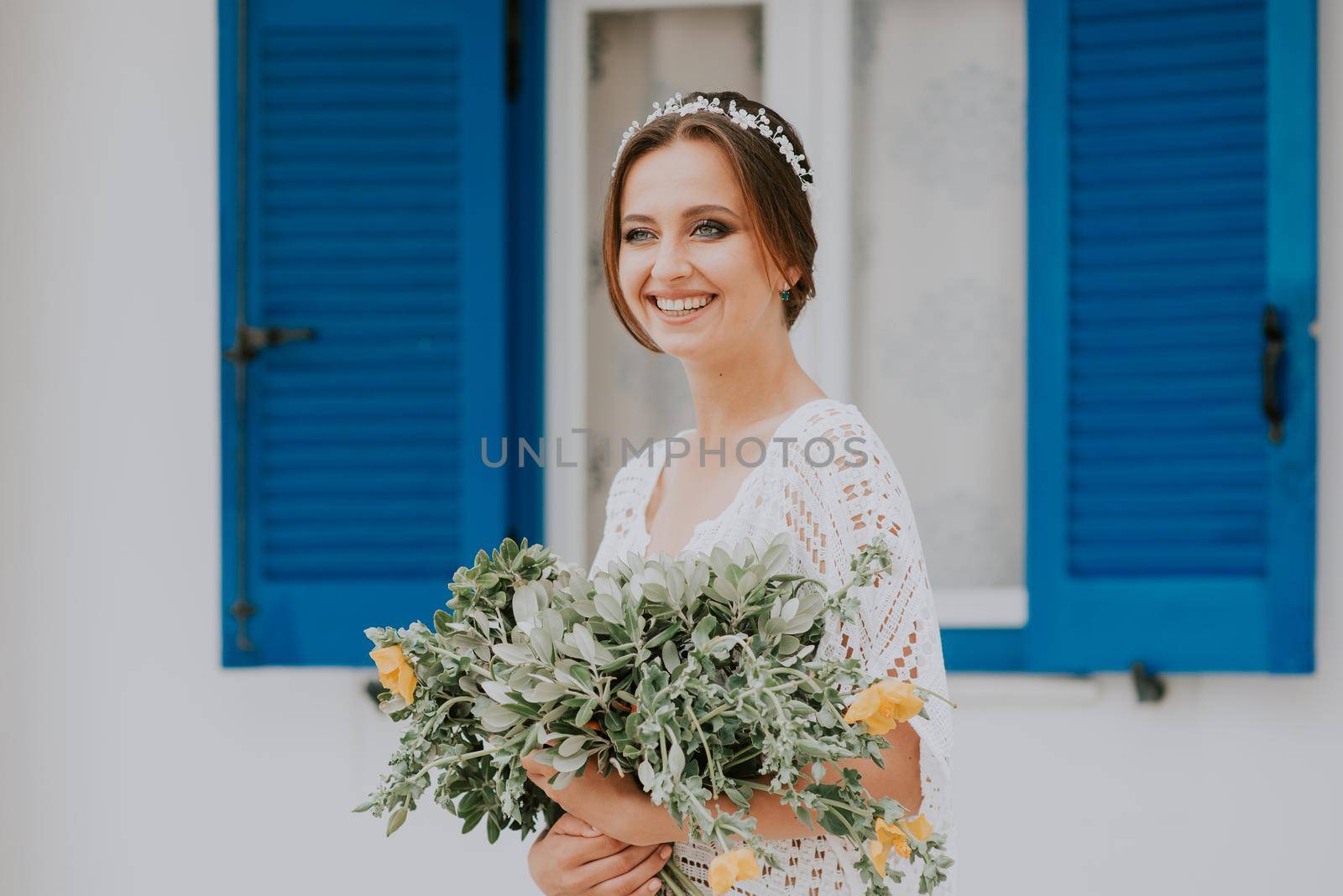 Beautiful wedding couple on a background of white architecture on Santorini island, Greece