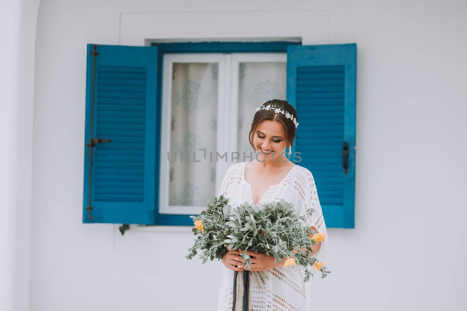 Young attractive bride with the bouquet of flowers by Andrii_Ko