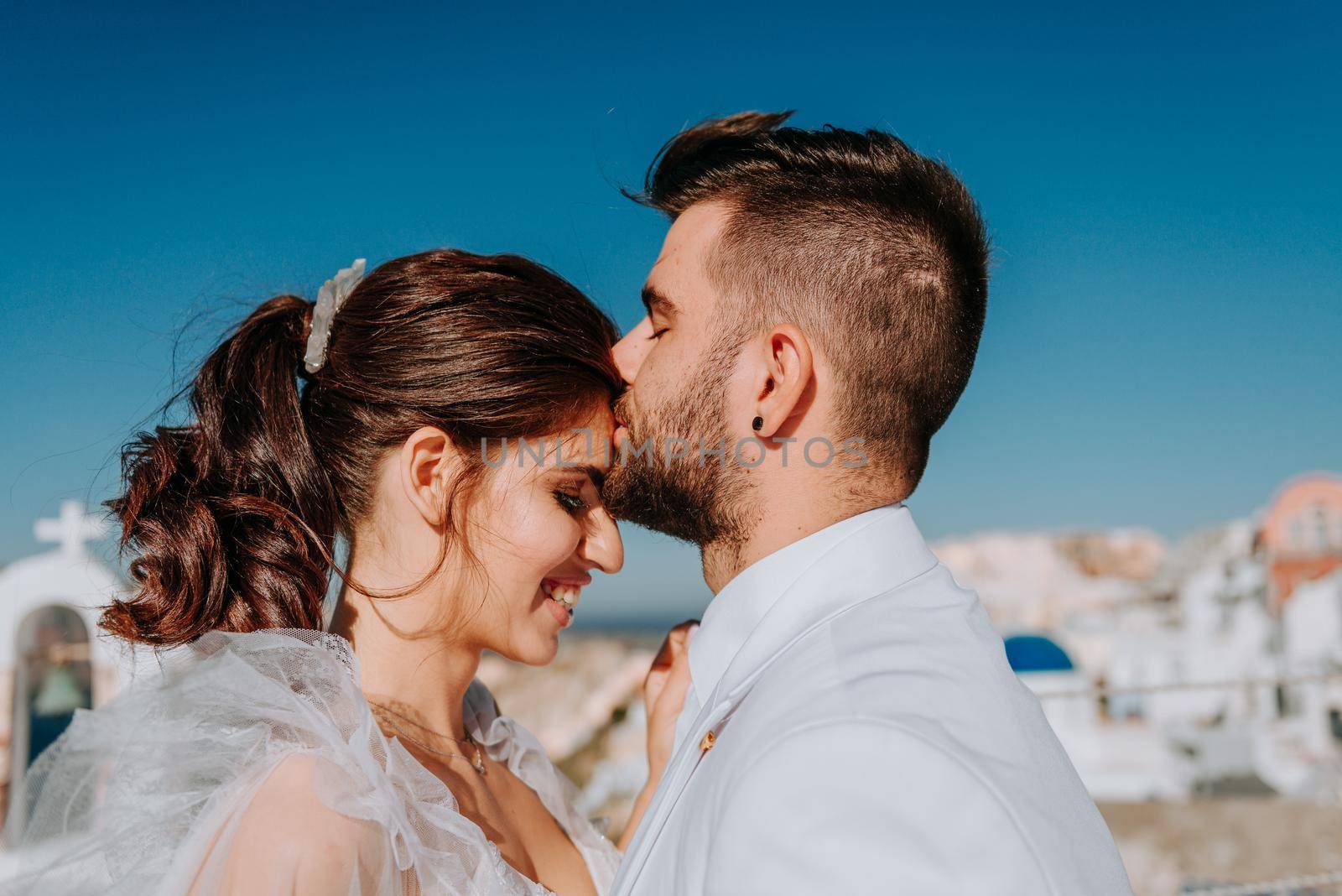 beautiful bride and groom in their summer wedding day on greek island Santorini.