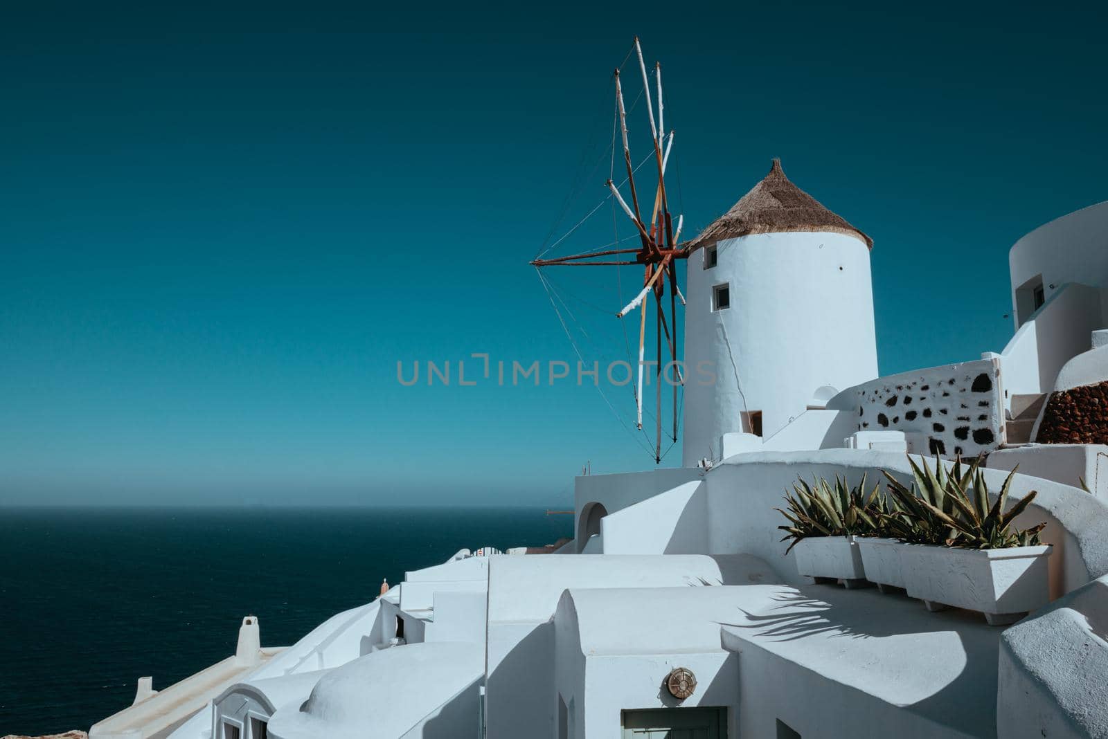 Oia Santorini in summer. White buildings of santorini. Mill Houses Santorini. by Andrii_Ko