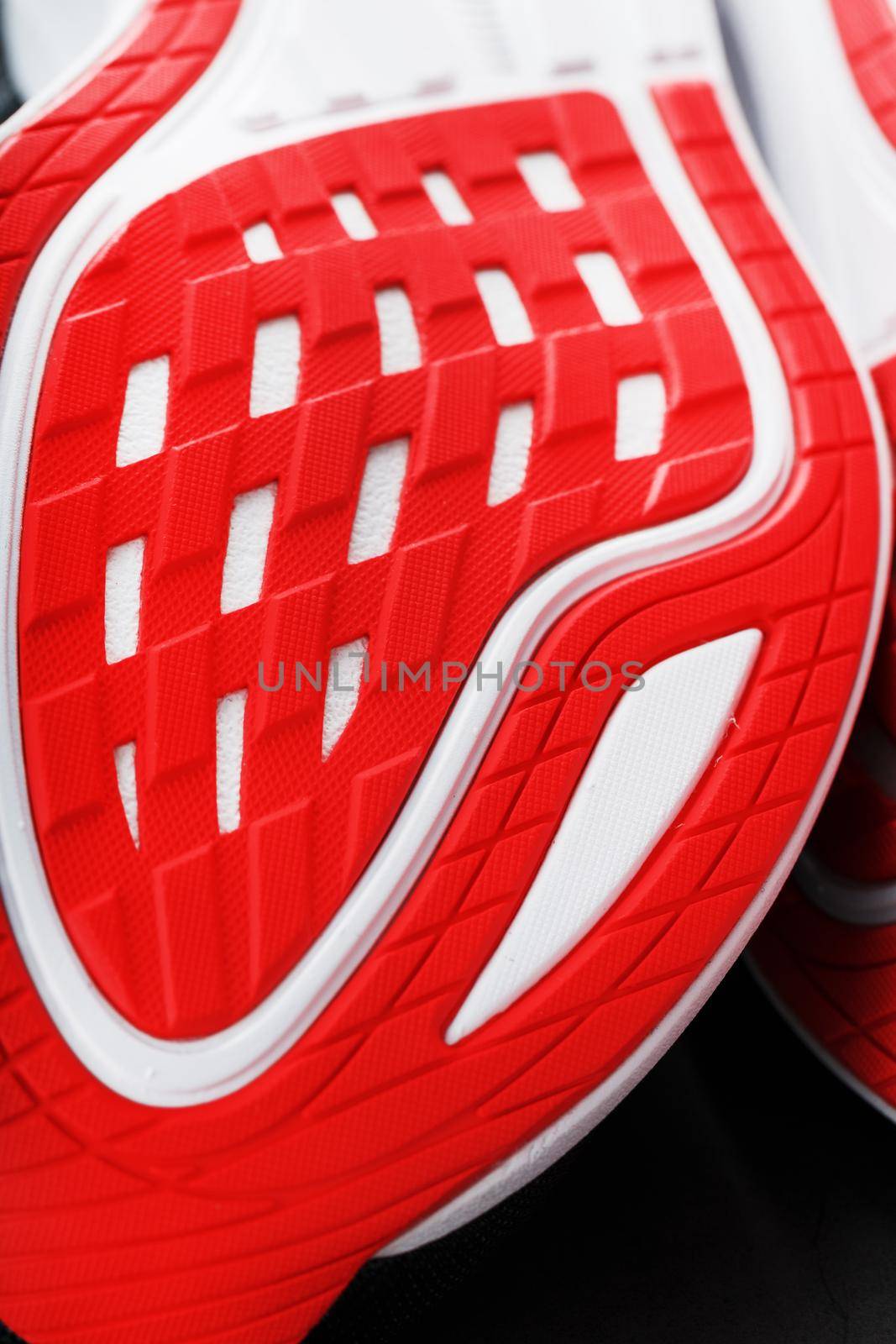 Close-up of the sole of a sport running shoe for running in red by AlexGrec