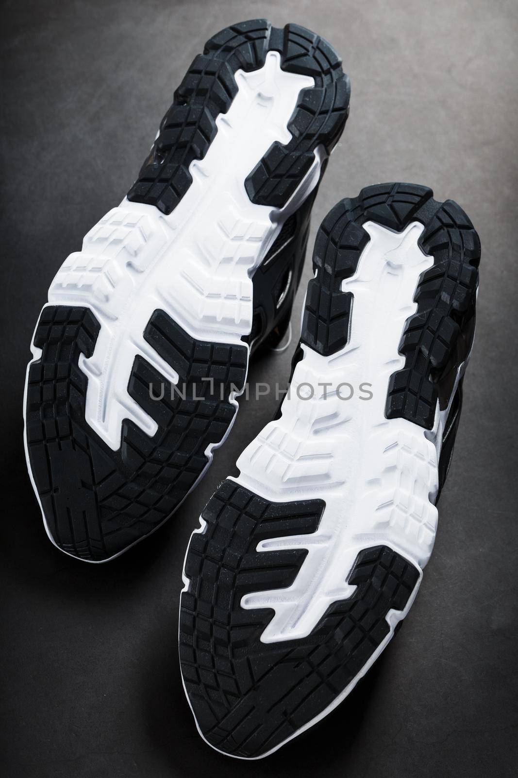 The black and white sole of trendy sports sneakers is a close-up in full screen. by AlexGrec