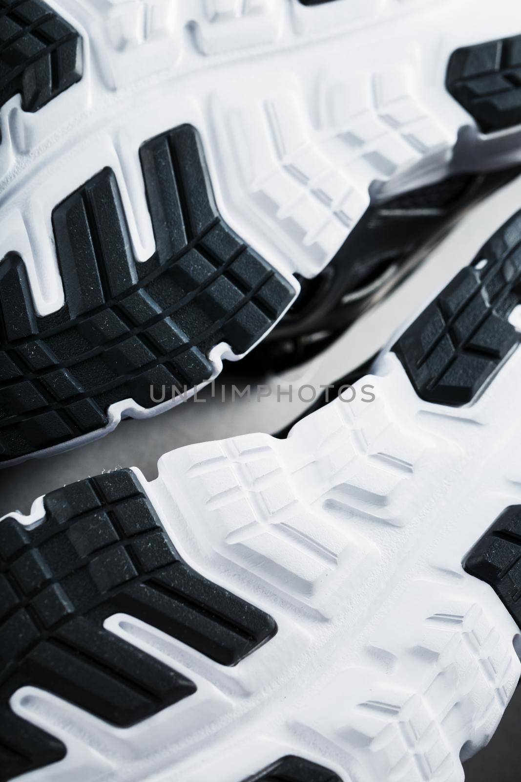 The sole of the sports sneakers for running in black and white close-up by AlexGrec