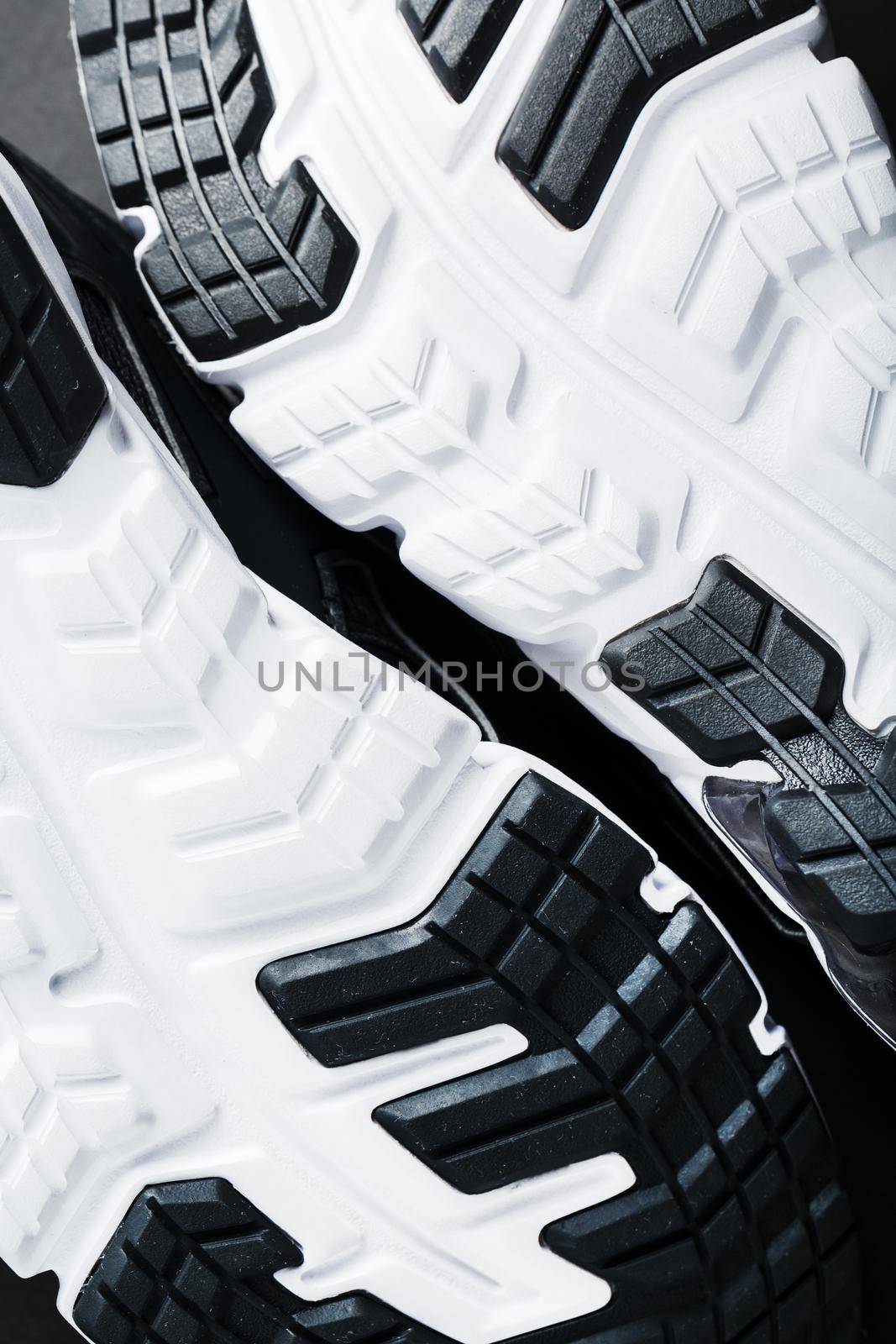 The black and white sole of trendy sports sneakers is a close-up in full screen. Shoe cushioning technology