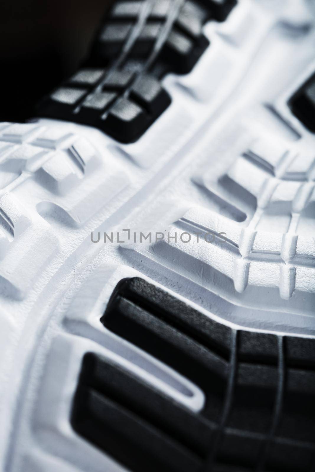 The black and white sole of trendy sports sneakers is a close-up in full screen. Shoe cushioning technology
