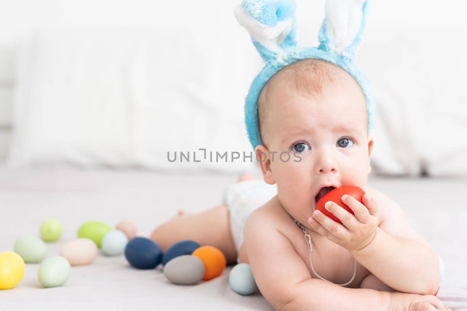 Newborn baby girl in a rabbit ears. Easter Holiday.