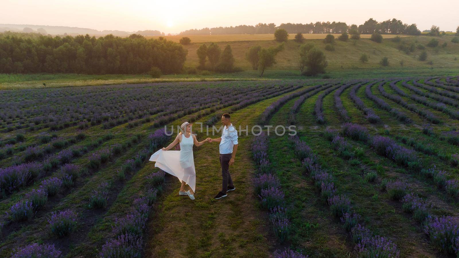 Young couple playing around in the lavender fields by Andelov13