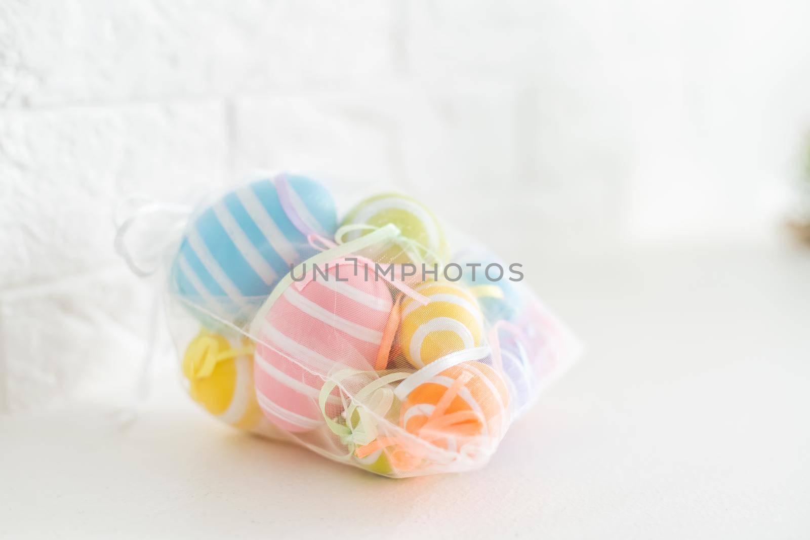 Creatively Easter painted eggs in a bag on a white background. Flat lay, copy space