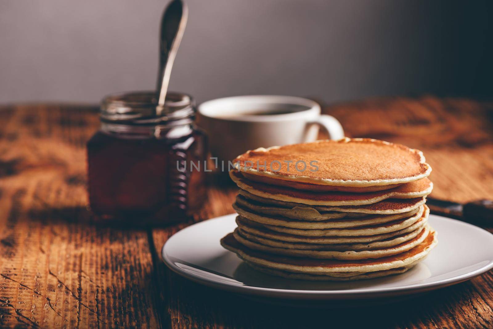 Stack of pancakes on white plate by Seva_blsv