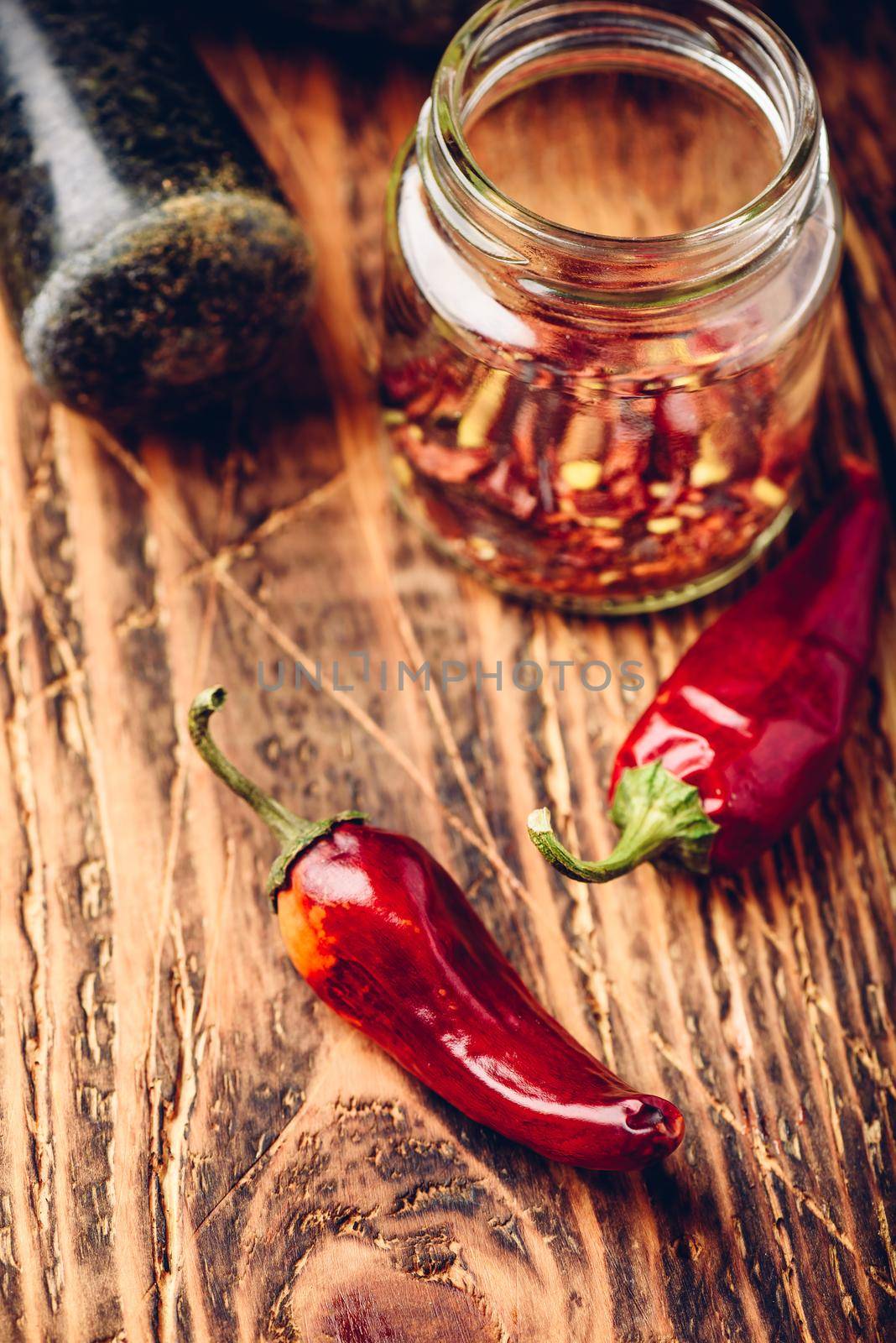Sun dried red chili peppers on wooden surface