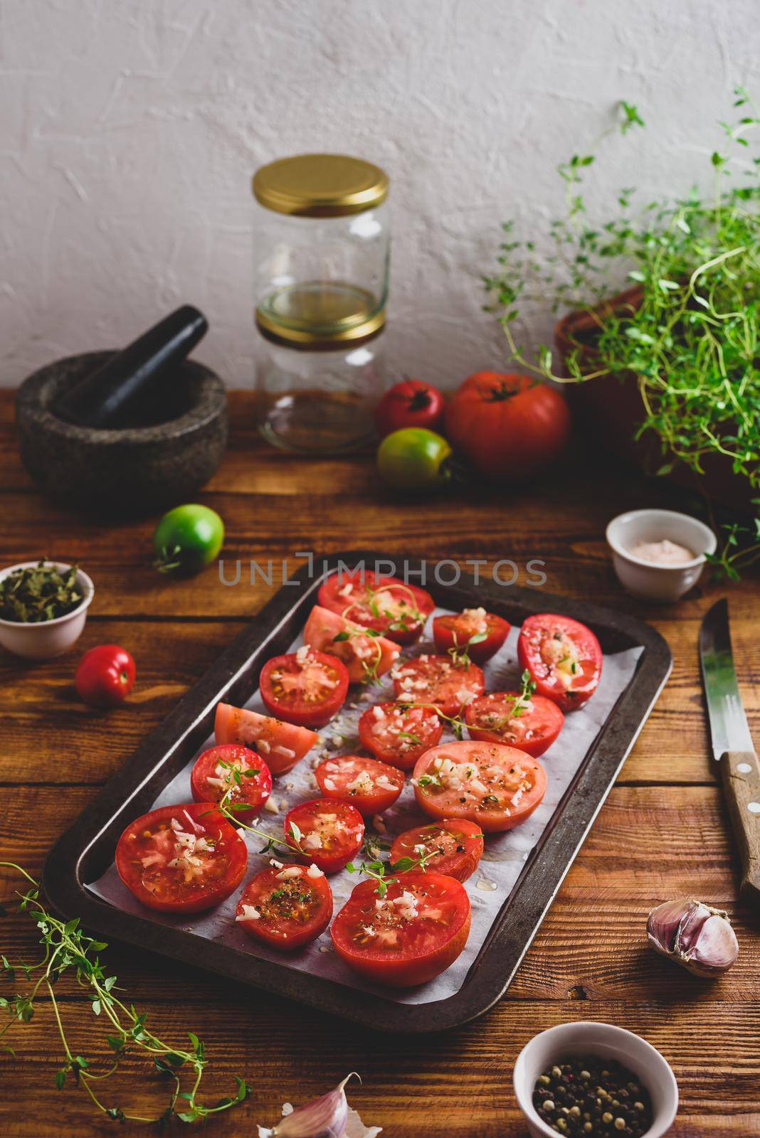 Sliced Tomatoes with Thyme and Garlic on Baking Dish by Seva_blsv