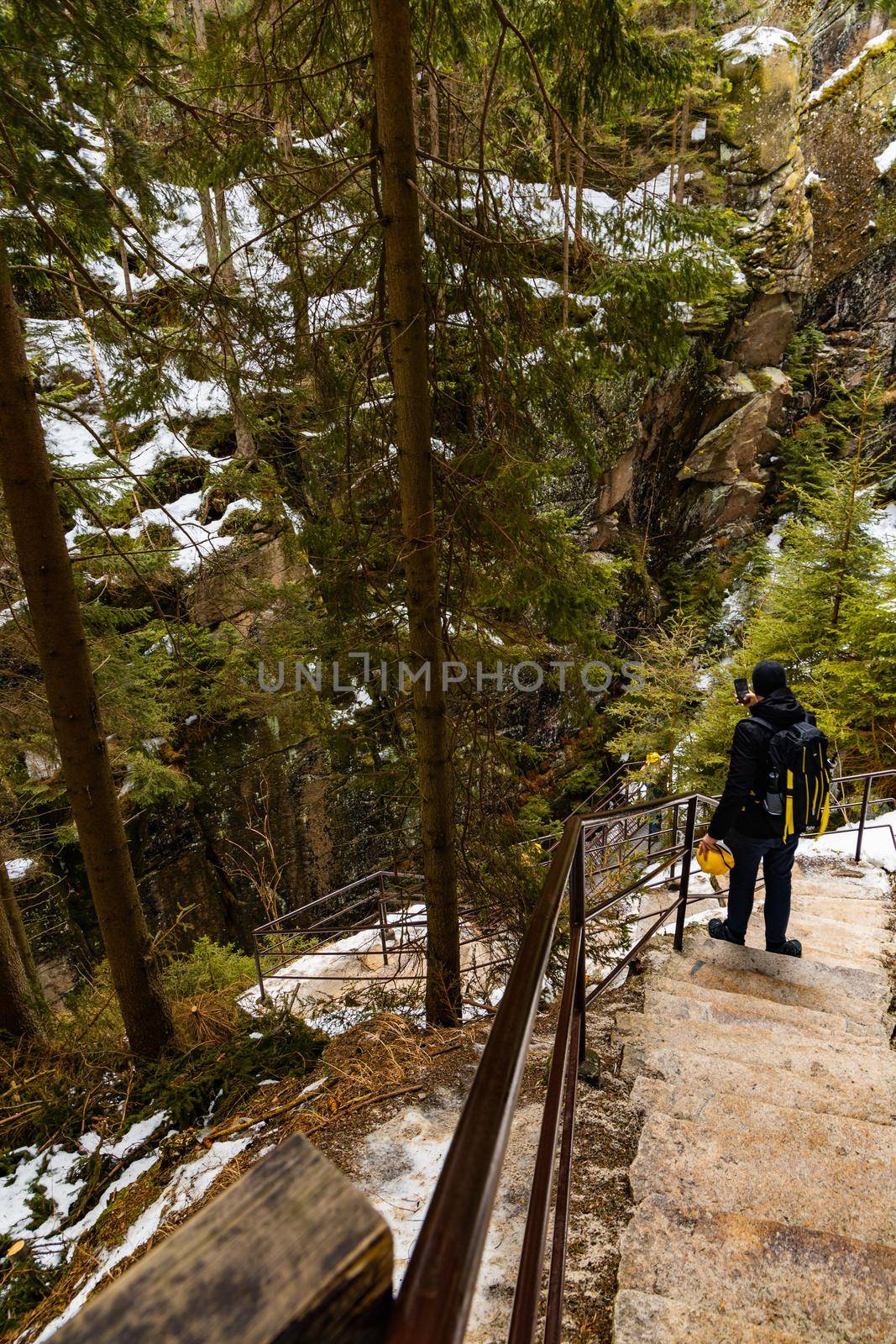 Man standing on concrete stairs and shooting a photo by phone by Wierzchu