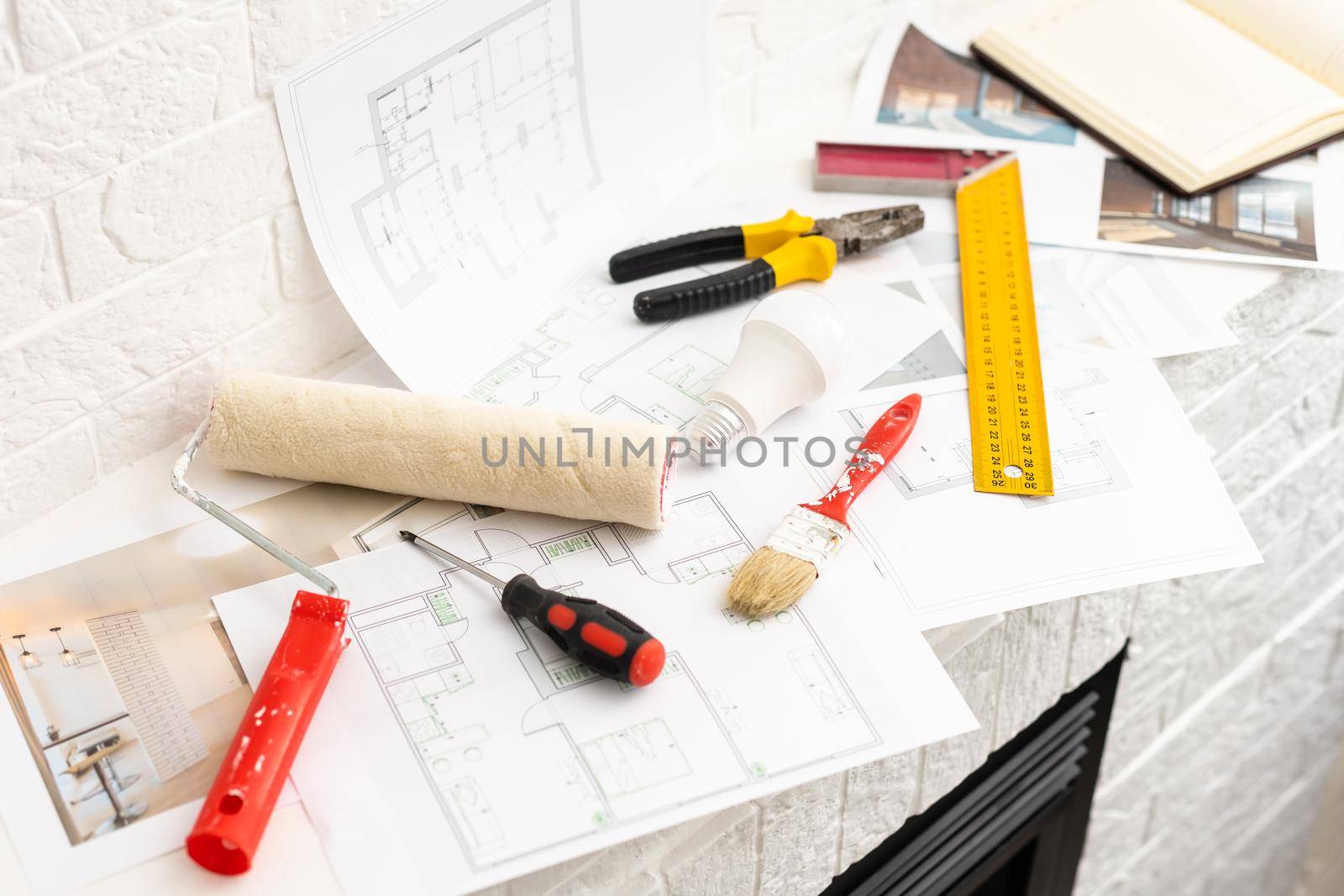 Construction blueprints with tools and tablet, top view.