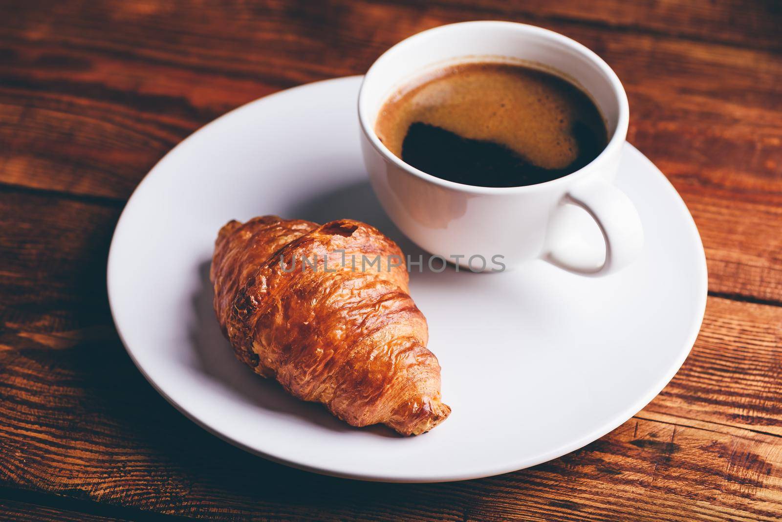 Cup of Black Coffee and Fresh Croissant by Seva_blsv