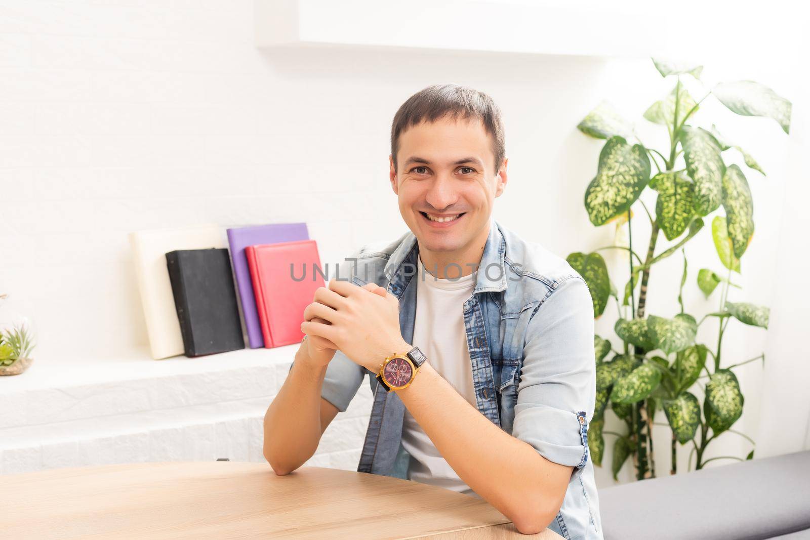 Attractive 30s caucasian businessman having online conversation using laptop at office desk