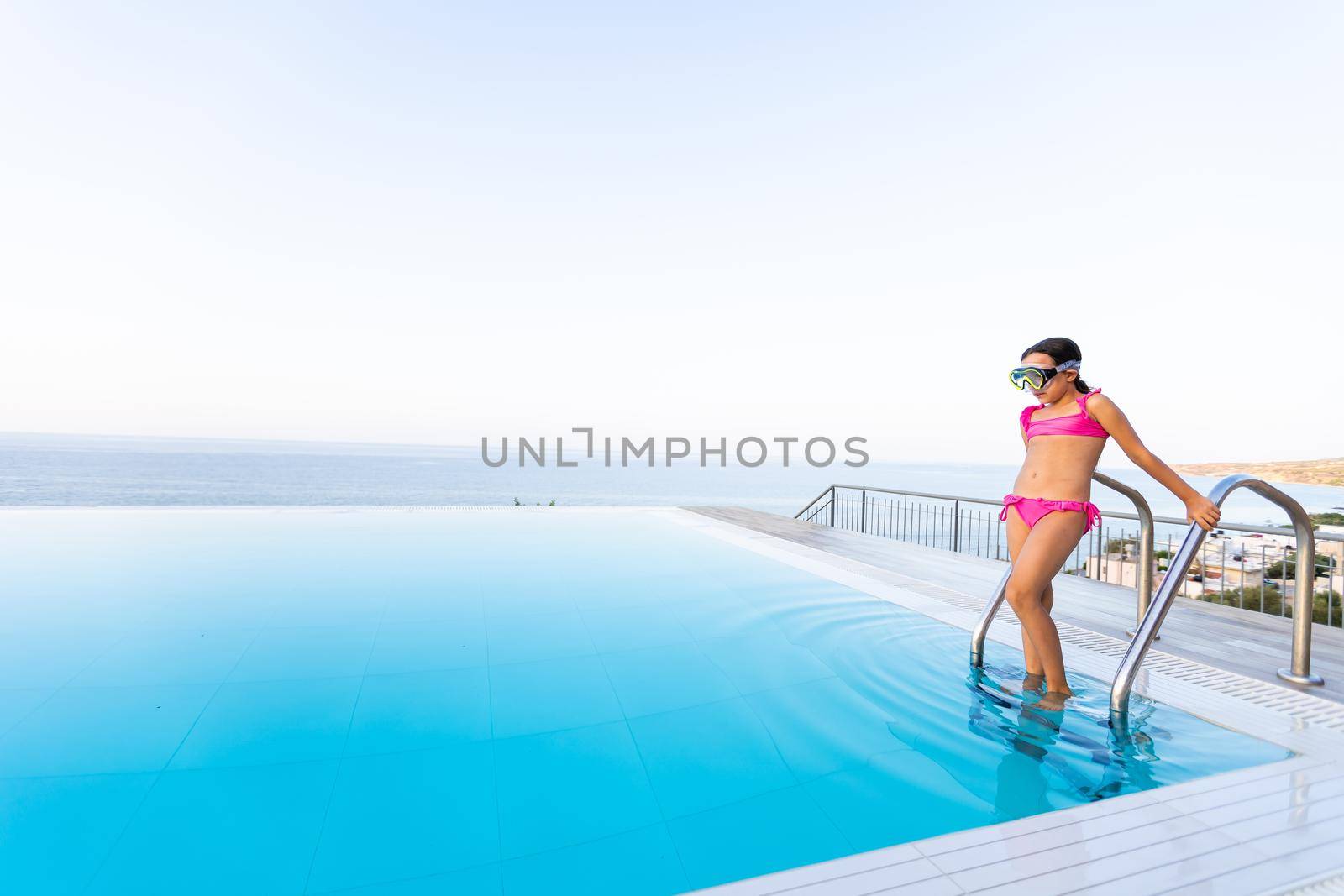 Young girl posing near swimming pool