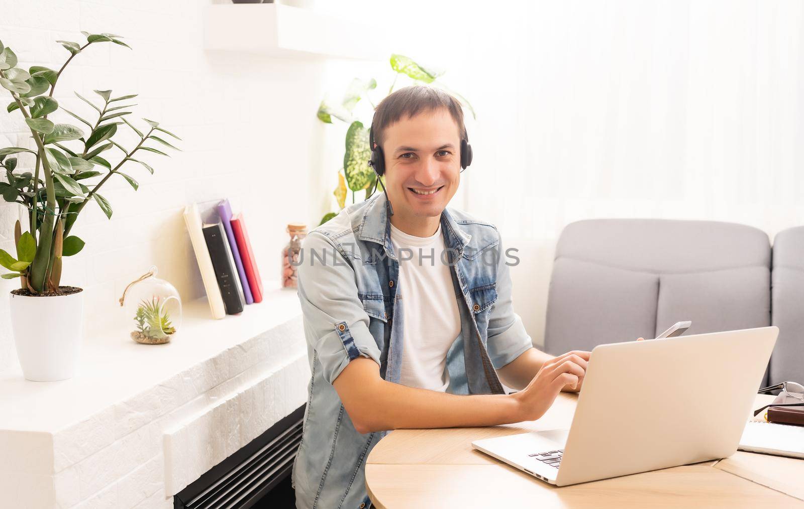 Man Using Laptop On Desk At Home