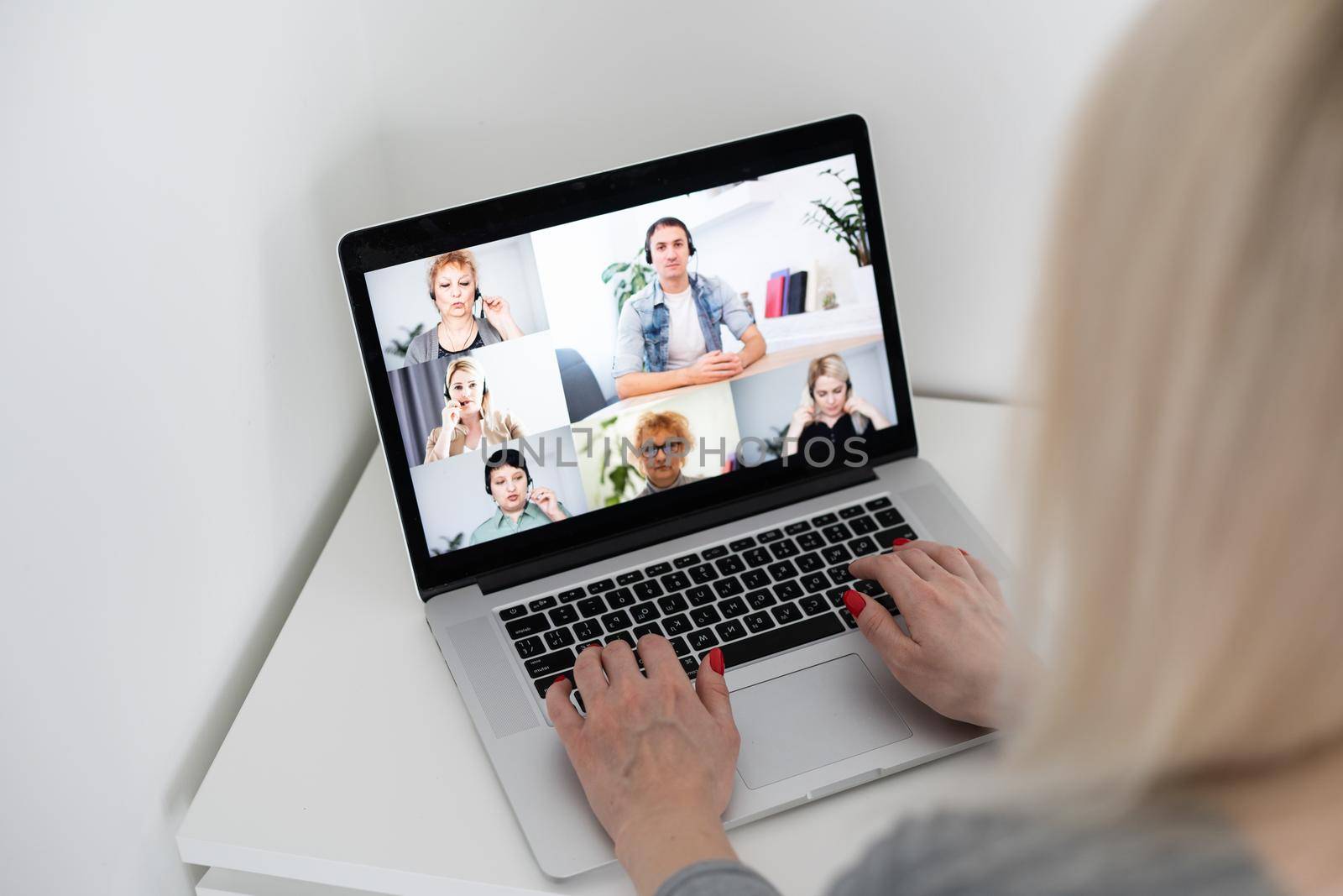 Woman Working From Home Having Group Videoconference On Laptop by Andelov13
