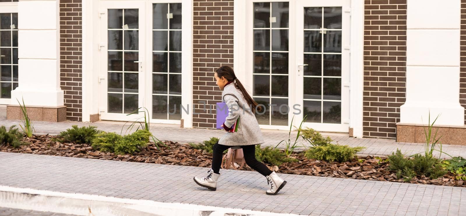 happy little girl running home from school.