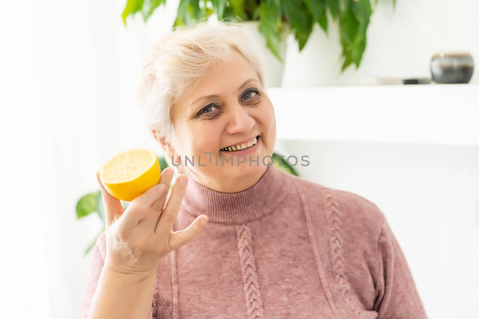 portrait of senior woman with lemon.