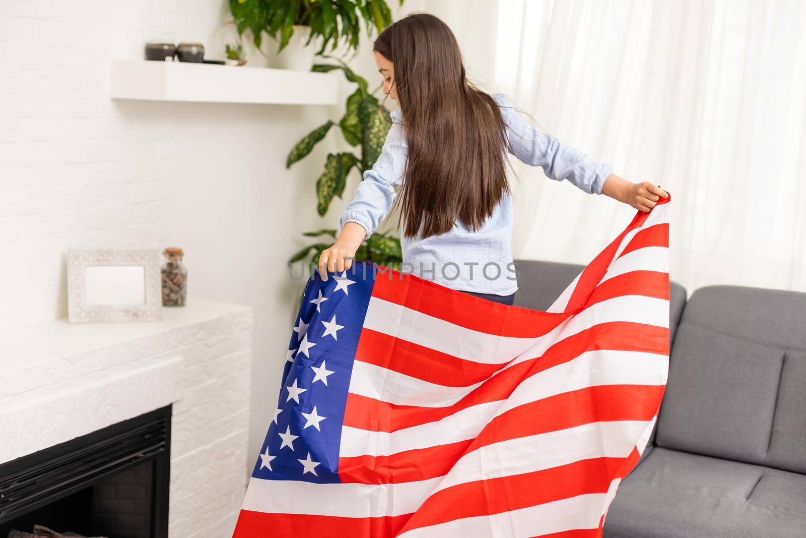 child holds a flag of America, USA. by Andelov13