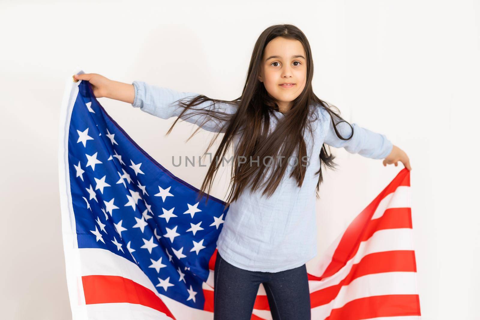 child holds a flag of America, USA. by Andelov13